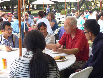faculty and students talking outdoors